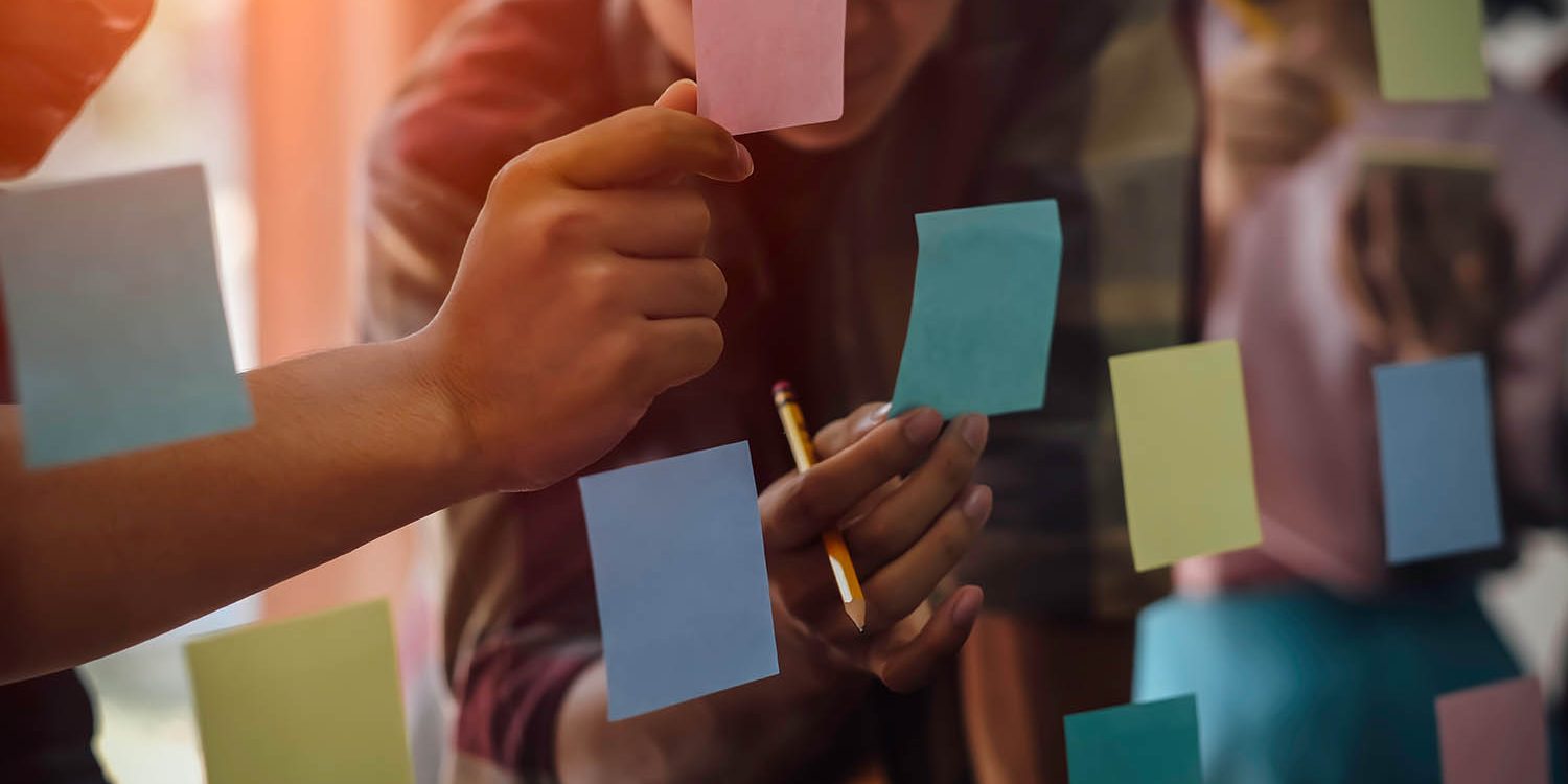 Co-Design Decorative. Figures collaborating and holding post-it notes